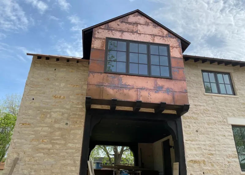 Copper metal panel facade on a stone building for Skylight Installation in Country Club Hills