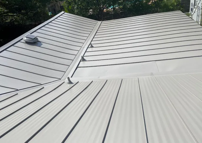 Solar attic fan installed on a metal roof for Roof Ventilation in Country Club Hills
